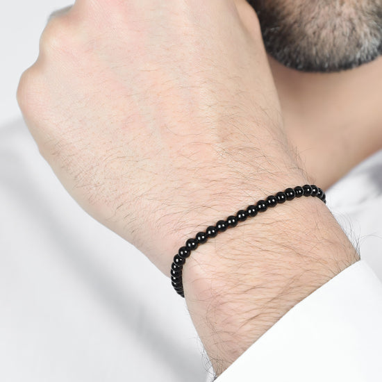 HERRENARMBAND AUS STAHL MIT SCHWARZEN PERLEN